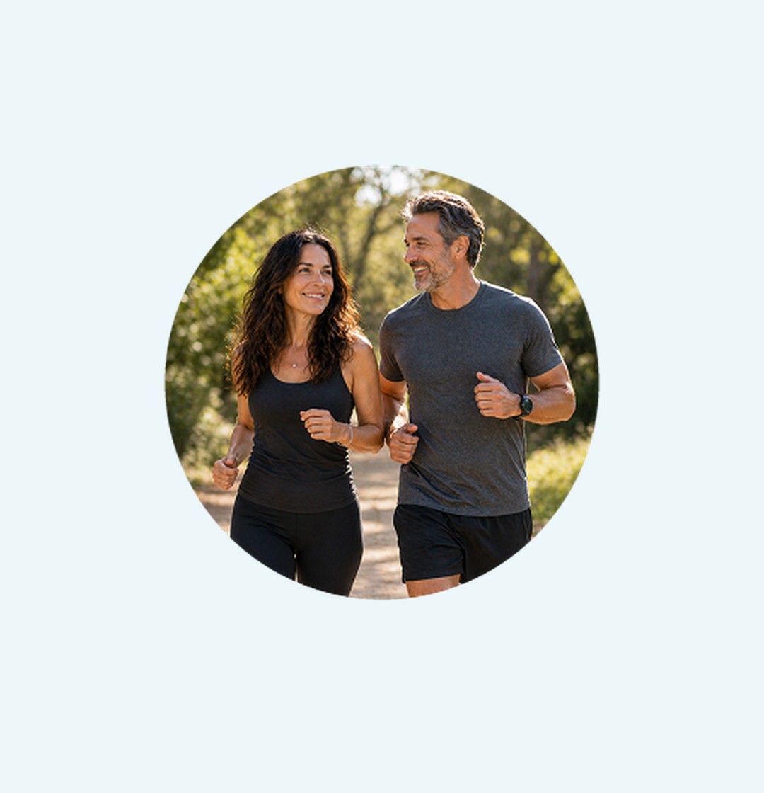 A smiling couple jogging on a trail